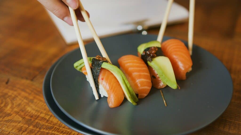 Slices of seafood on top of a black plate
