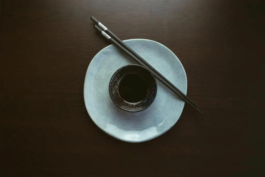 Chopsticks next to soy sauce