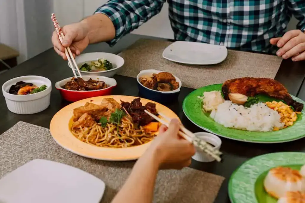 People eating using chopsticks