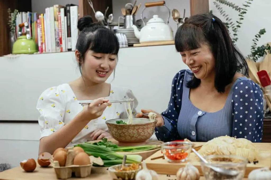 A mother and daughter eating ramen together