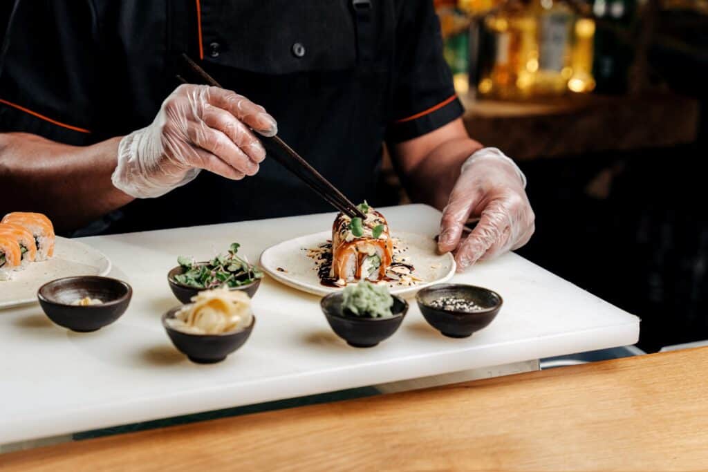 A sushi chef preparing a nice sushi roll