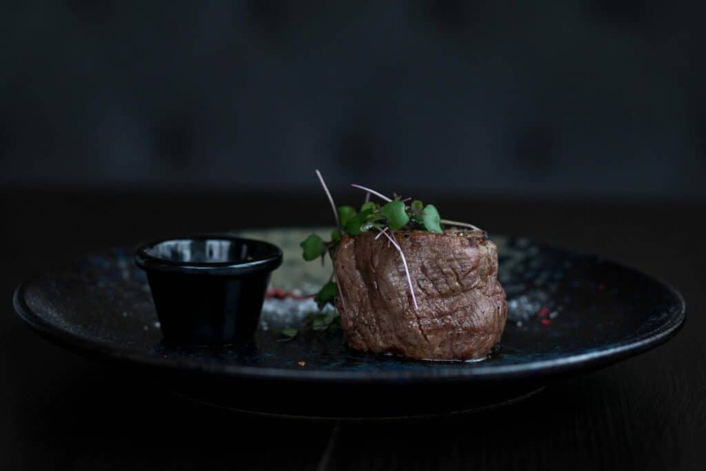 Steak served in luxurious black ceramic plates