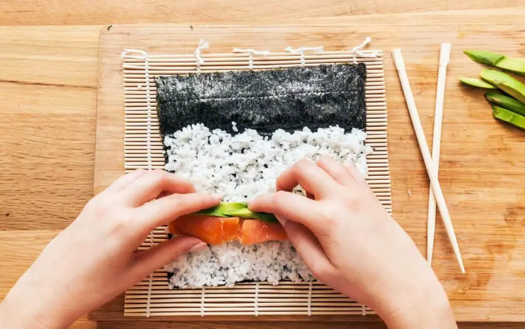 A person making a sushi roll