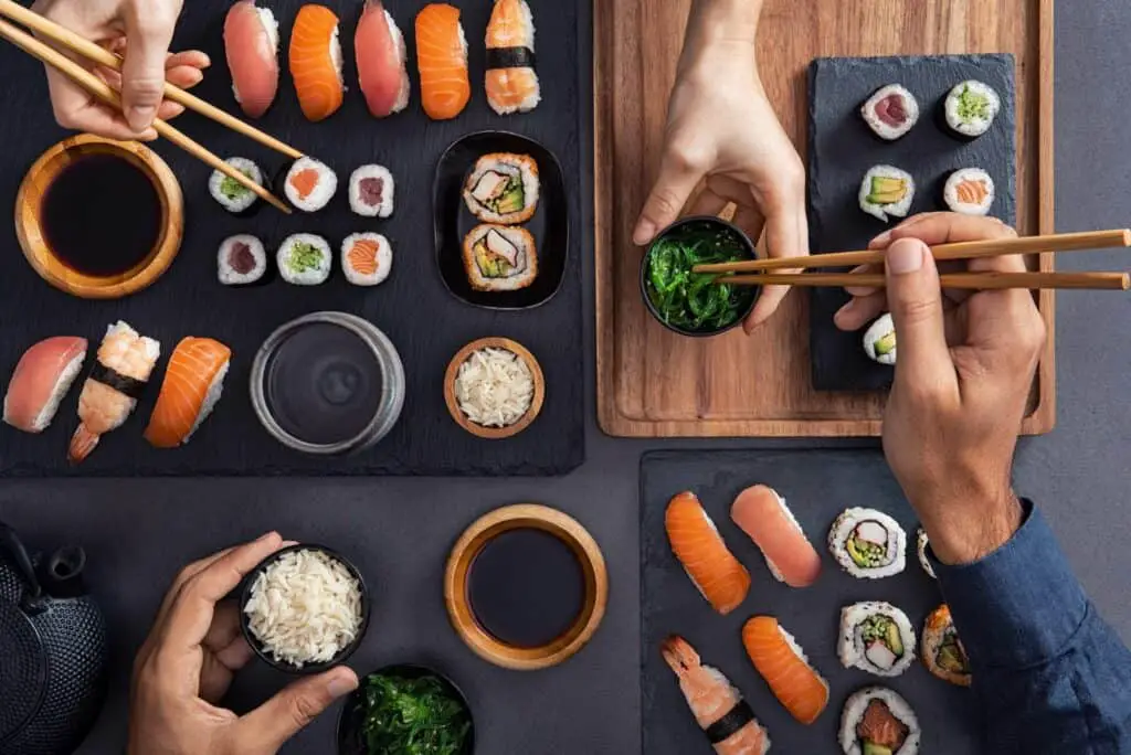 Two people eating sushi