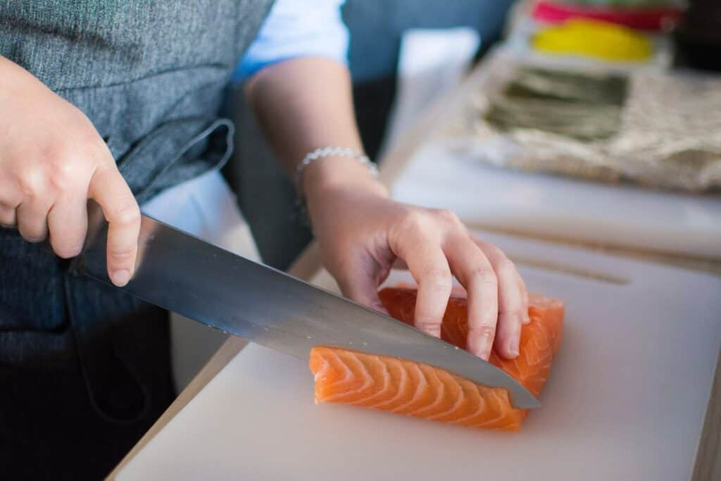 A woman slicing salmon