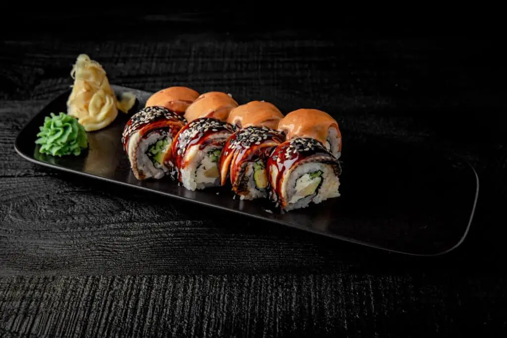 Sushi rolls on a black plate