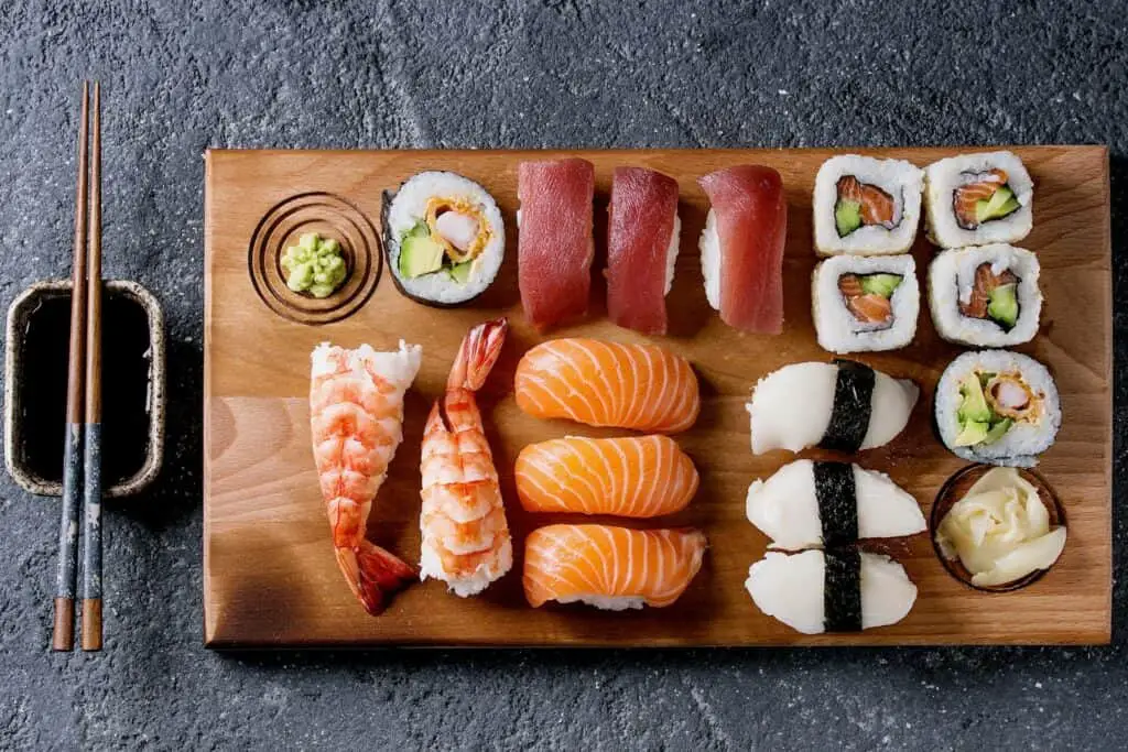 Nigiri and sushi rolls on a wooden serving board