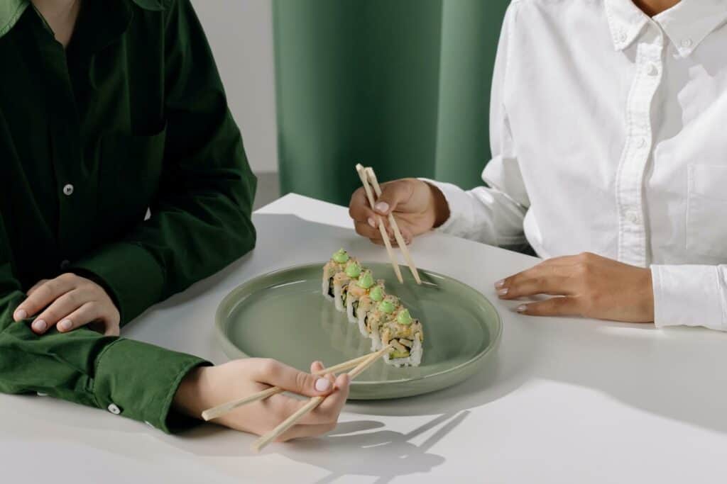 People eating sushi rolls