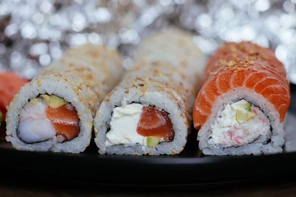 Three large sushi rolls on a plate