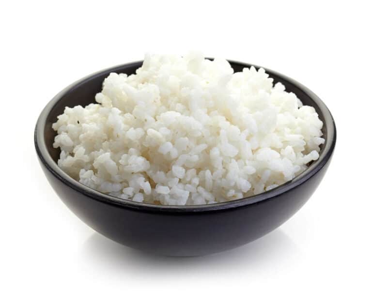 A small black bowl filled with white rice