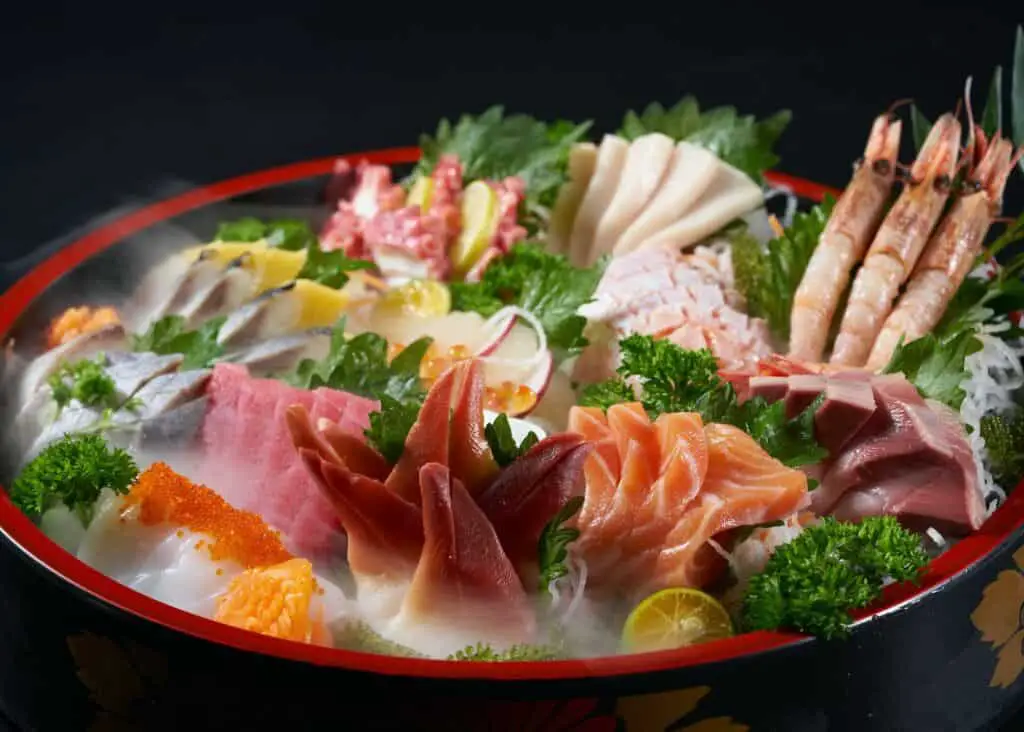 A bowl of iced raw seafood slices