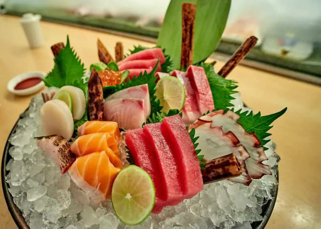 An iced bowl filled with raw fish and shellfish slices