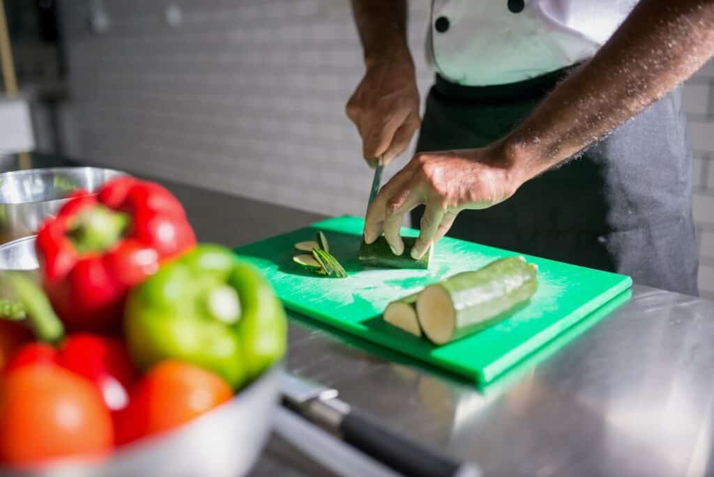 Man slicing cucumber