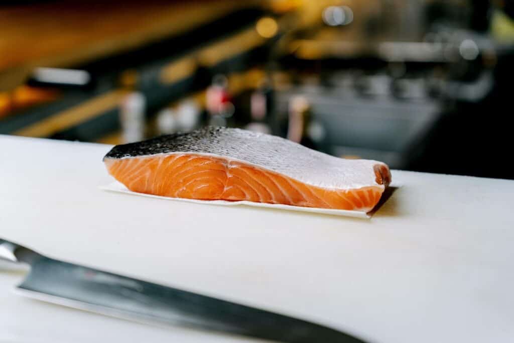 A piece of raw salmon on the white surface