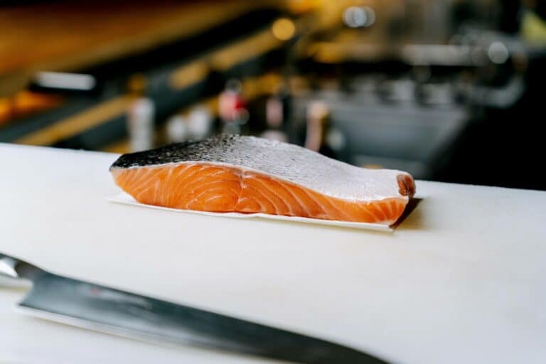 A piece of raw salmon on the white surface