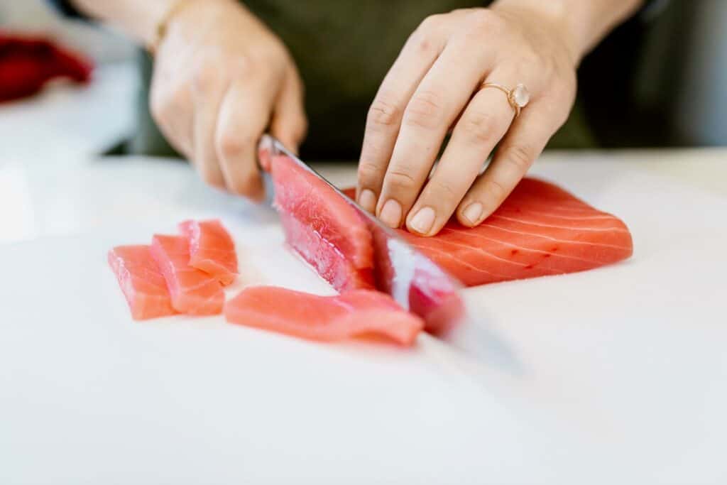 Woman slicing a fish