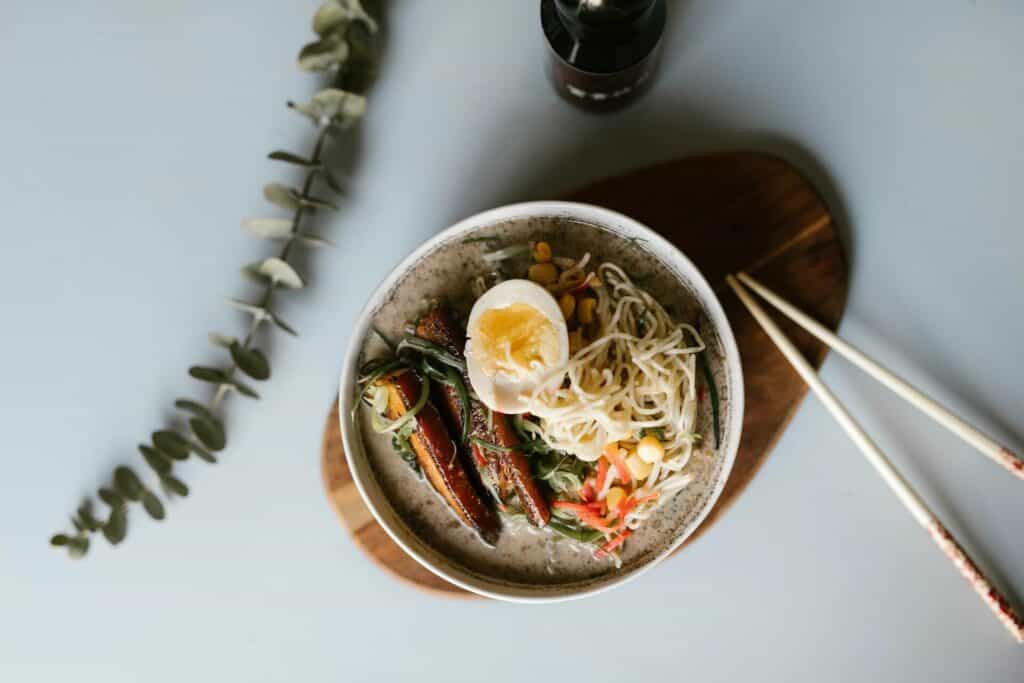 A bowl of ramen with chopsticks beside