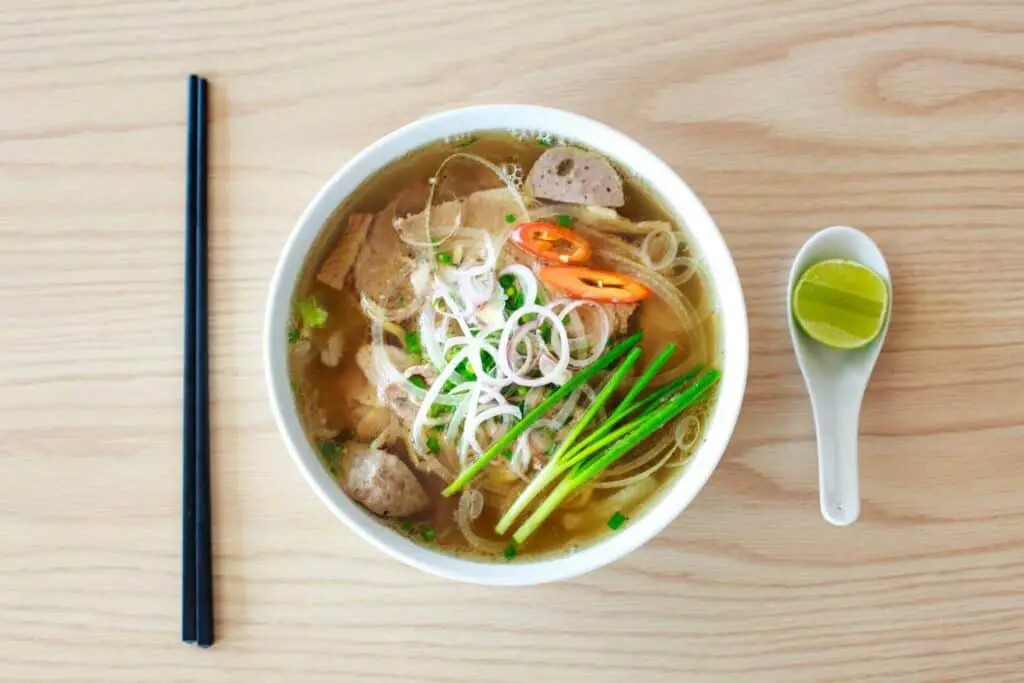 A clear soup bowl filled with meat and vegetables