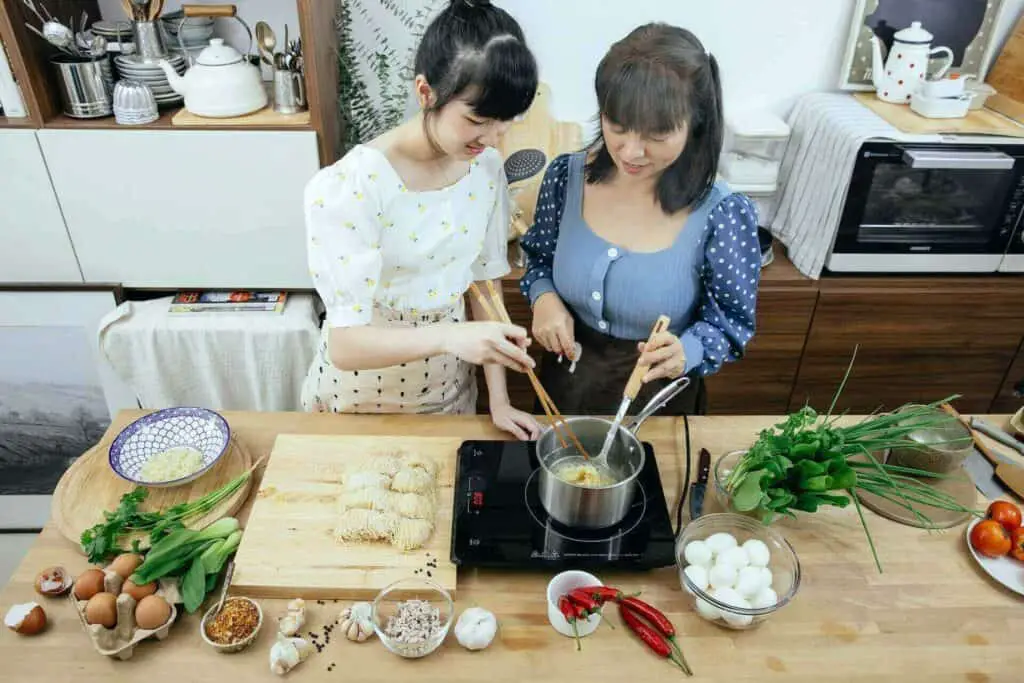 Two women cooking ramen