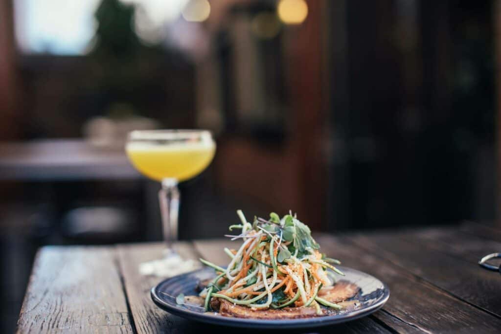 Noodle salad and cocktail in a bar