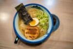 Ramen with meat, noodles, an egg, and nori