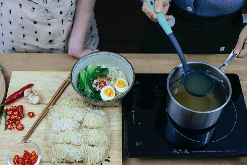 Two people preparing ramen