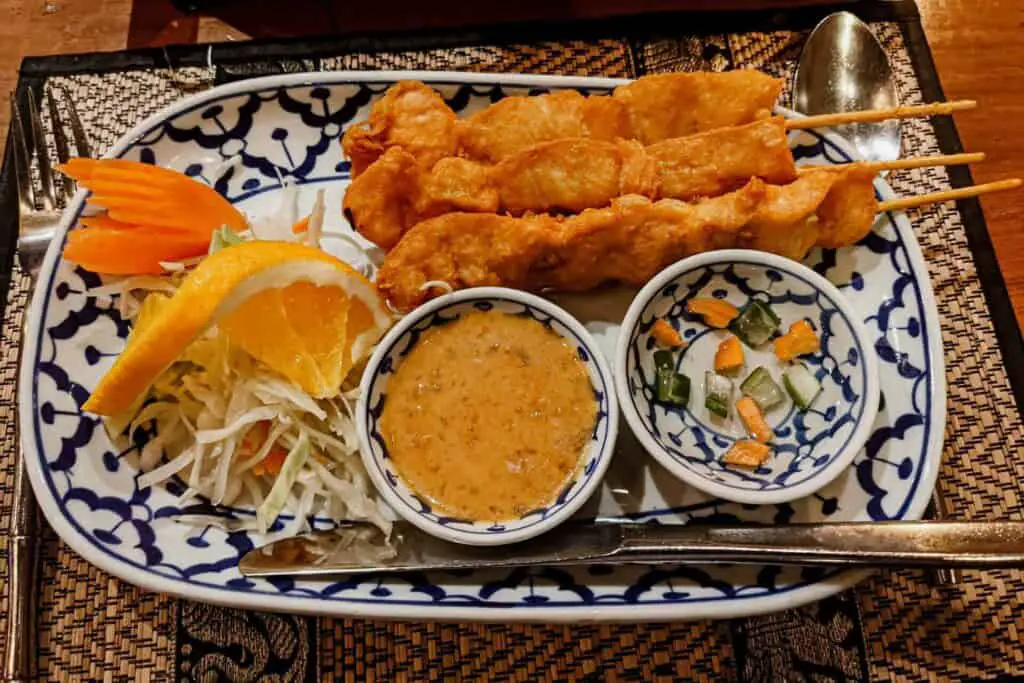 Tempura crab on sticks with sauce and garnish